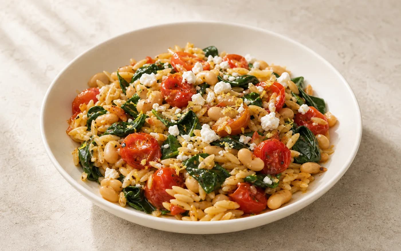 Roasted tomato orzo with white beans and spinach